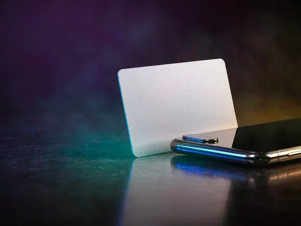 m444 Blank card beside a smartphone
