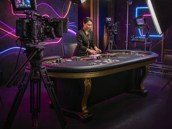 m444 Camera and studio lighting face a casino table